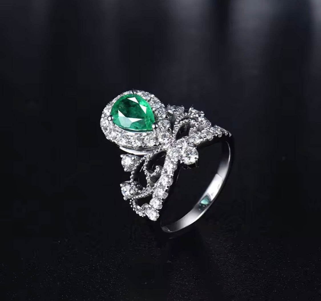 18K white gold emerald diamond ring with pear cut emerald and crown princess halo design
