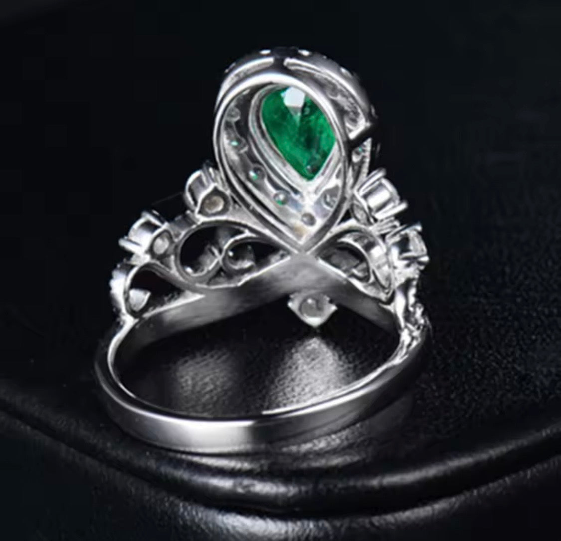 18K white gold emerald diamond ring with pear cut emerald and crown princess halo design