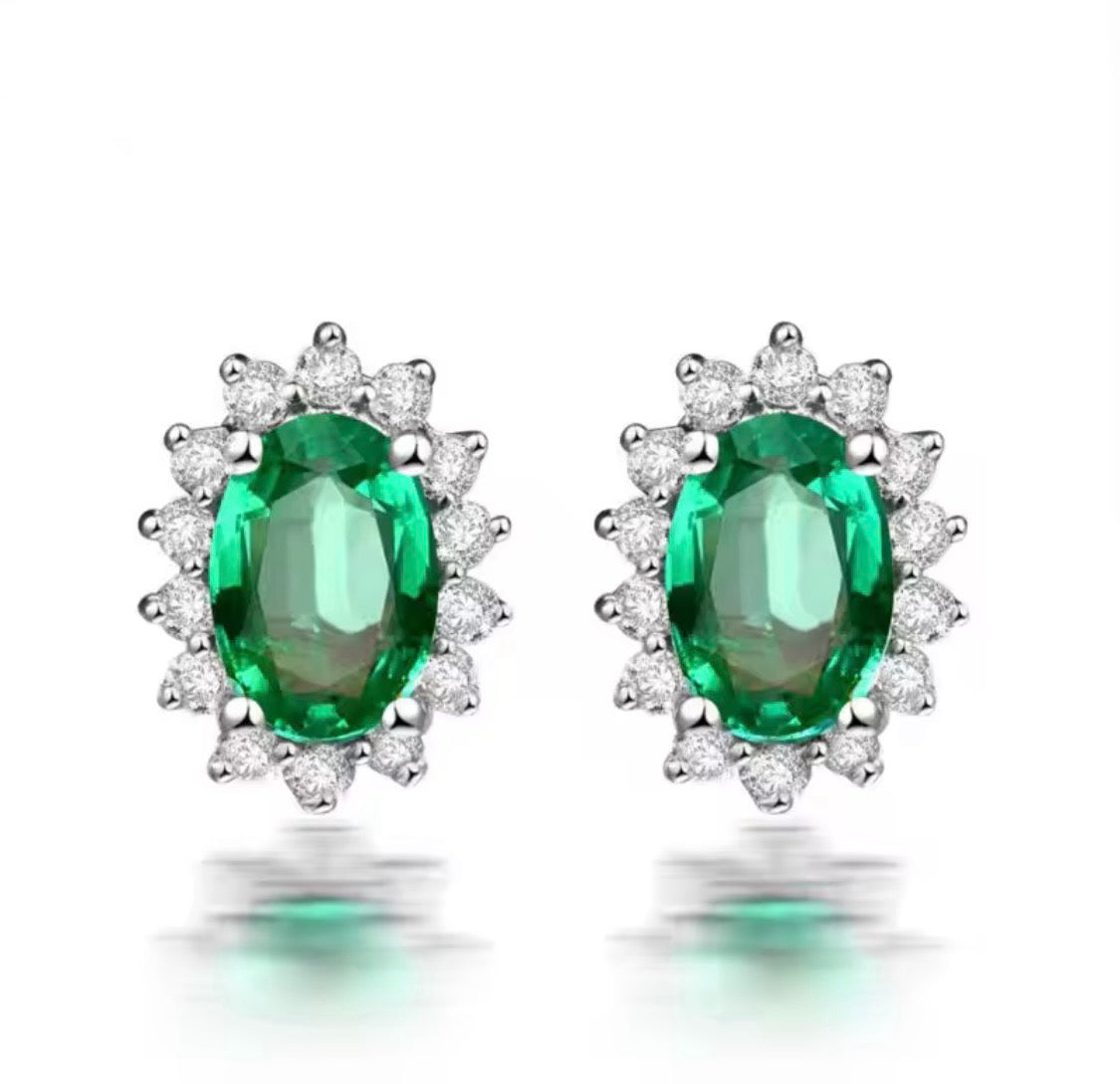 18K gold emerald stud earrings with oval 4x6mm gemstones and diamond halo design