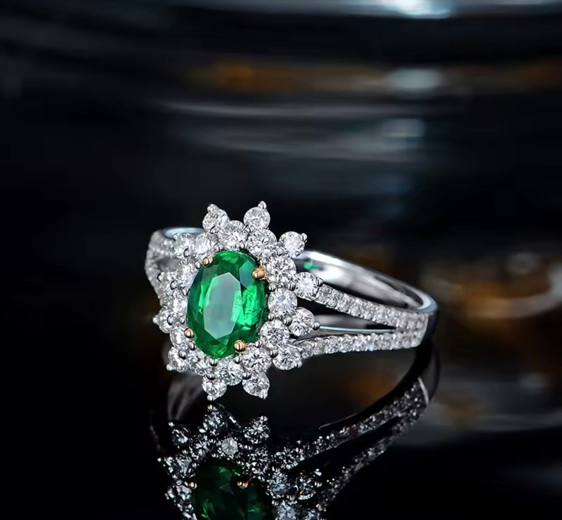 Natural oval emerald ring with diamond halo and split shank in white gold