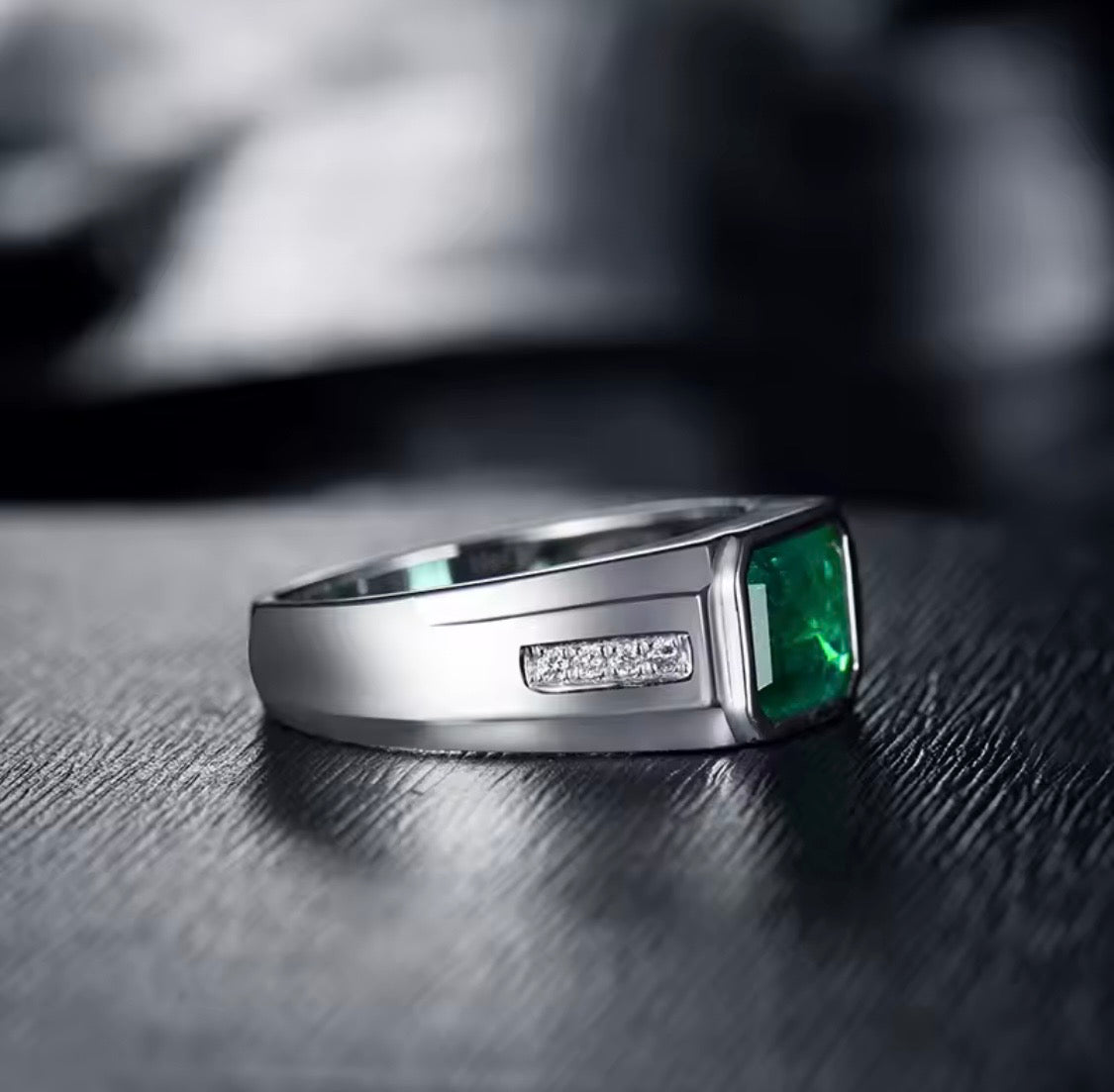 Natural emerald and diamond unisex statement ring in 18K white gold side view