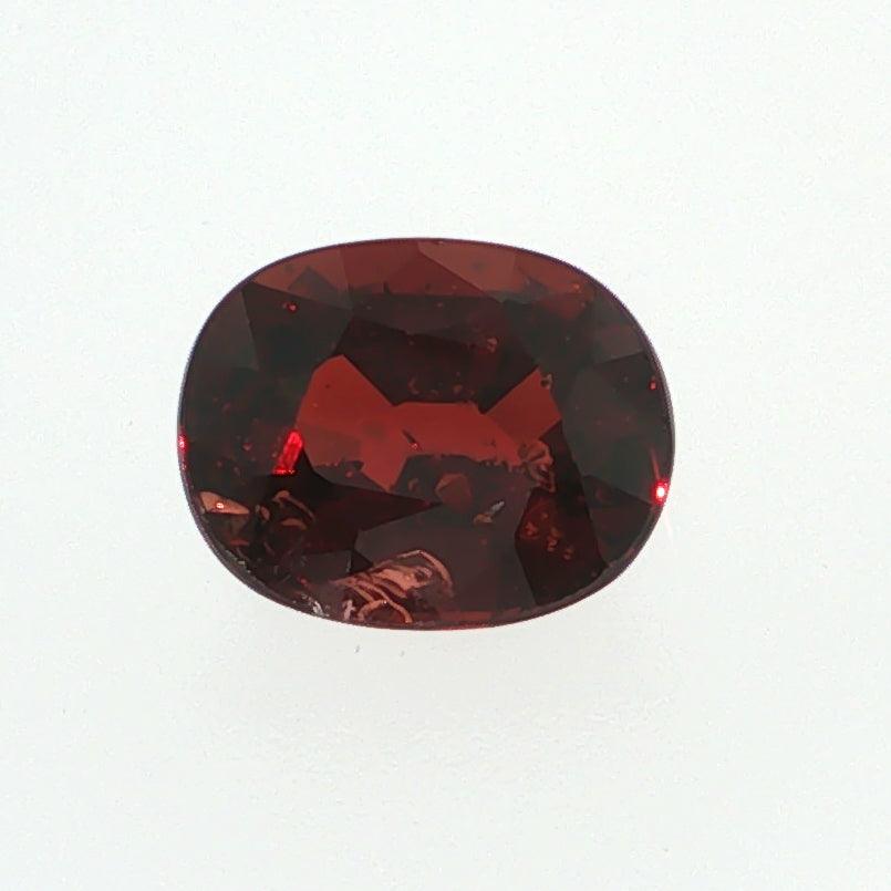 Natural pyrope-almandine garnet, 2.39 carats, oval cut, slightly orangy red color, transparent, ČGL certified gemstone