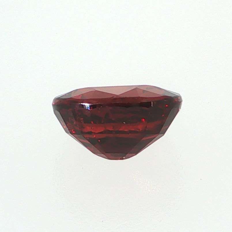 Natural pyrope-almandine garnet, 2.39 carats, oval cut, slightly orangy red color, transparent, ČGL certified gemstone