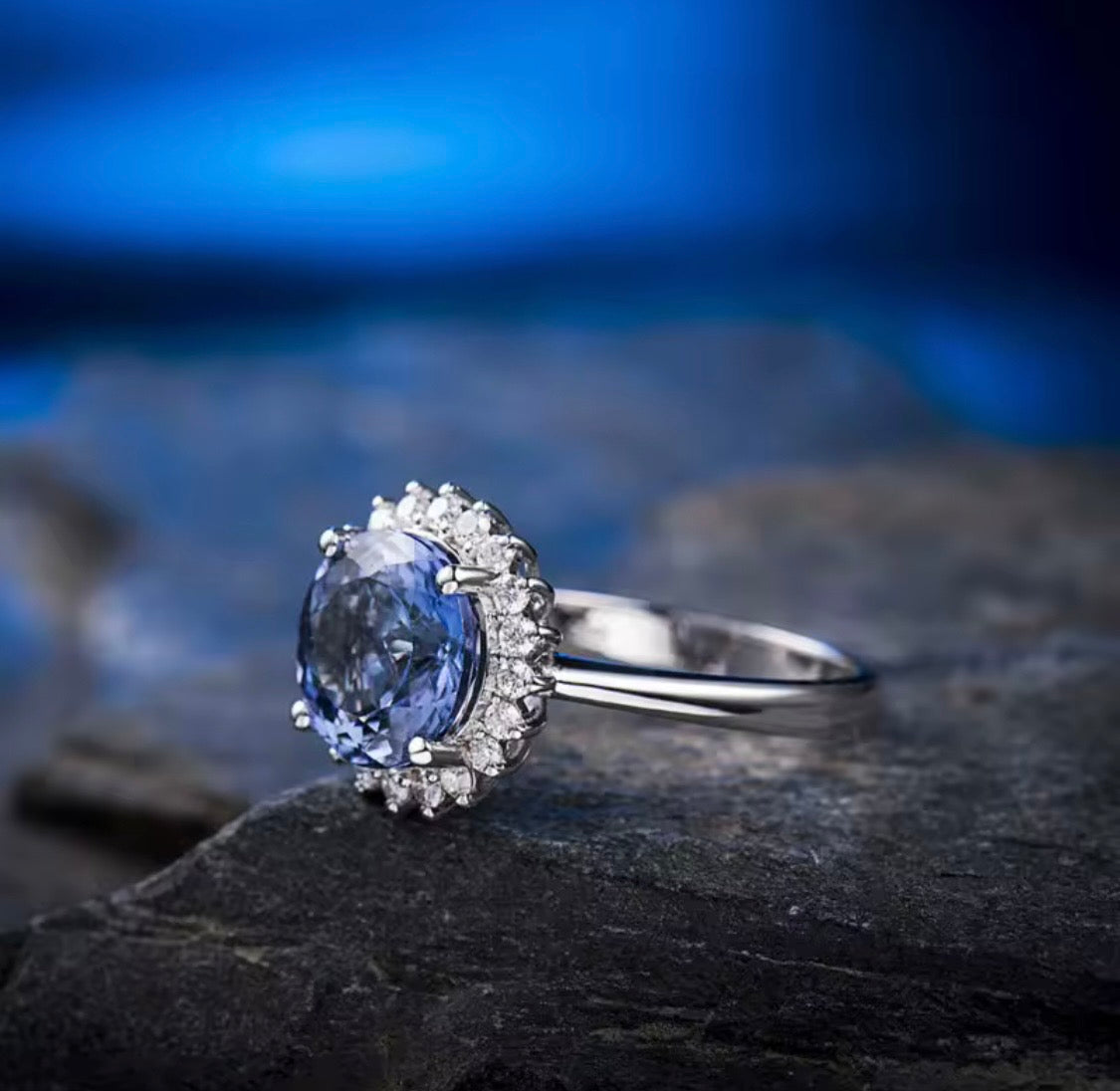 Natural round tanzanite and diamond halo ring in 18K white gold lifestyle view