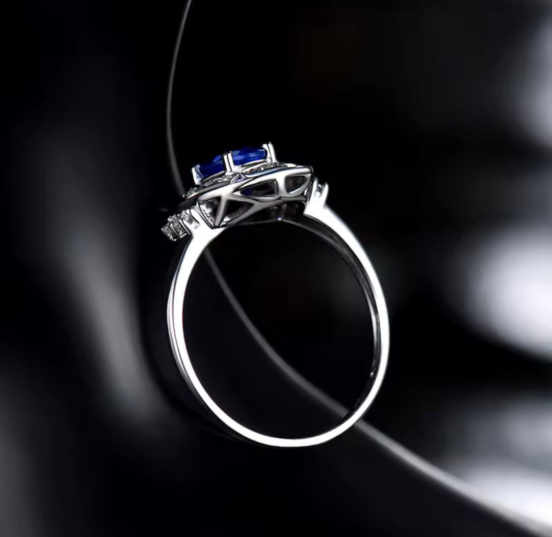 14K white gold tanzanite diamond ring with natural oval tanzanite and diamond halo design