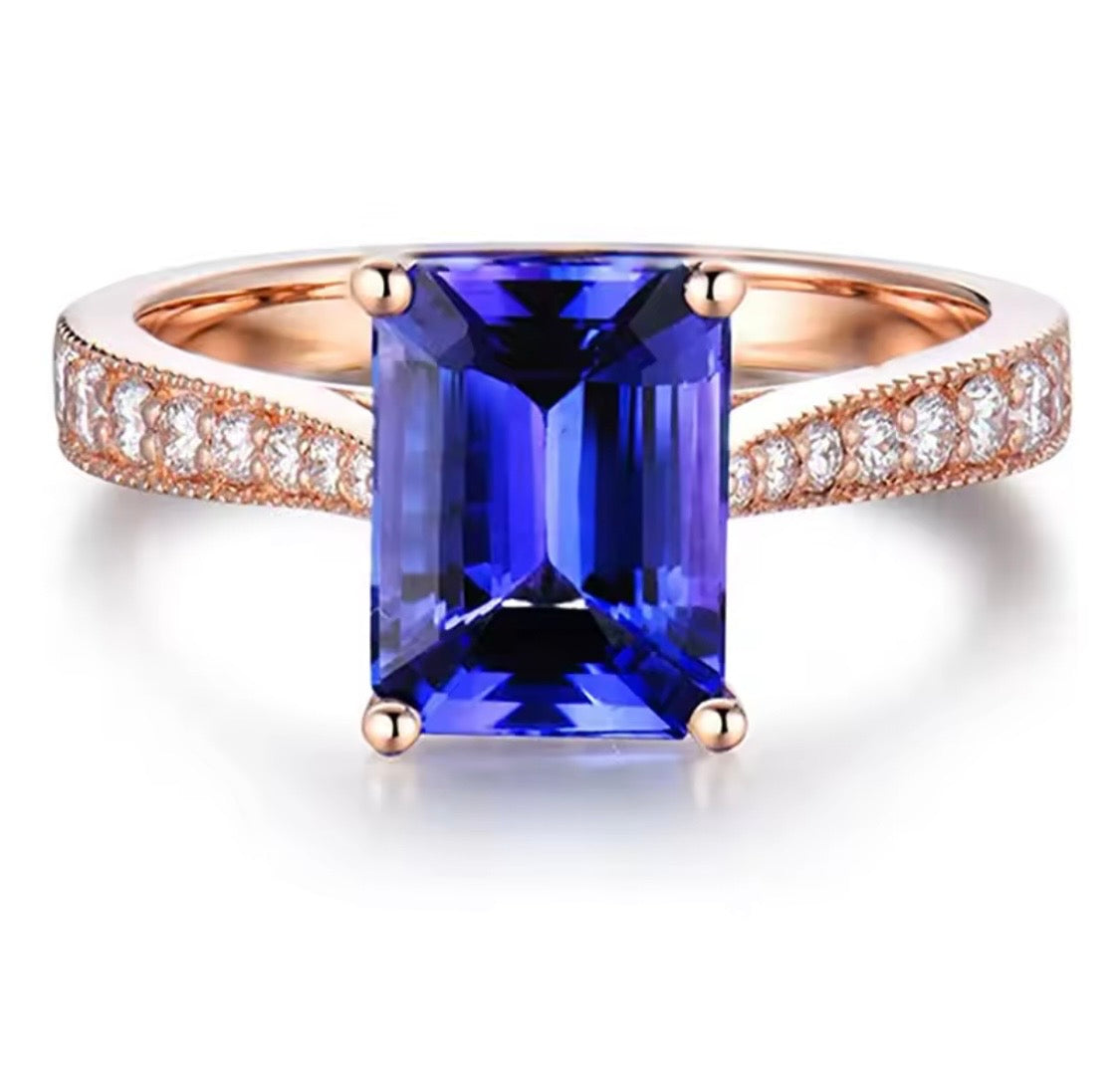 14K rose gold tanzanite engagement ring with natural emerald cut tanzanite and diamond band