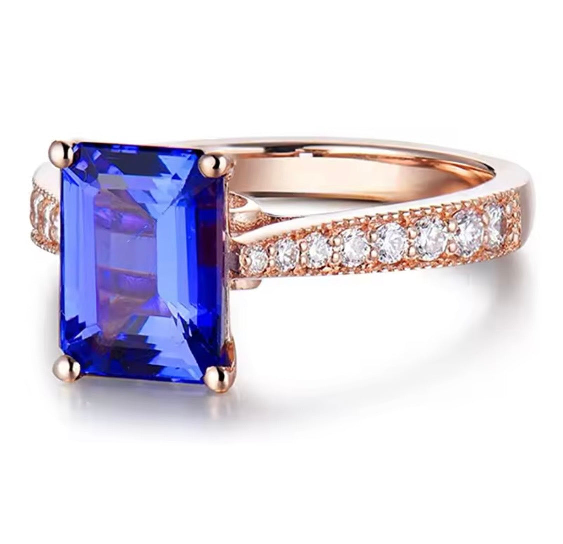 14K rose gold tanzanite engagement ring with natural emerald cut tanzanite and diamond band