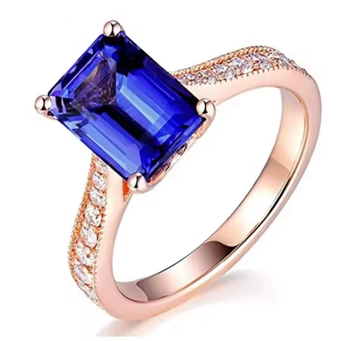 14K rose gold tanzanite engagement ring with natural emerald cut tanzanite and diamond band