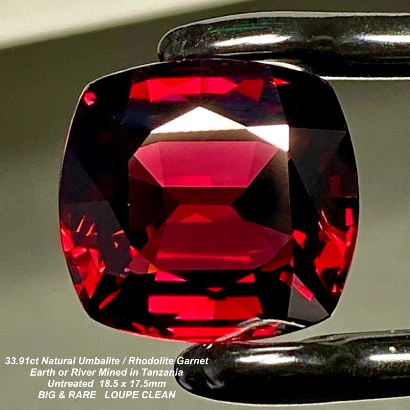 Natural garnet, dark, slightly purplish red, cushion cut, 33.92 ct, loose gemstone.