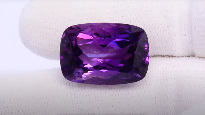 20.21 ct natural amethyst in cushion shape on hand 