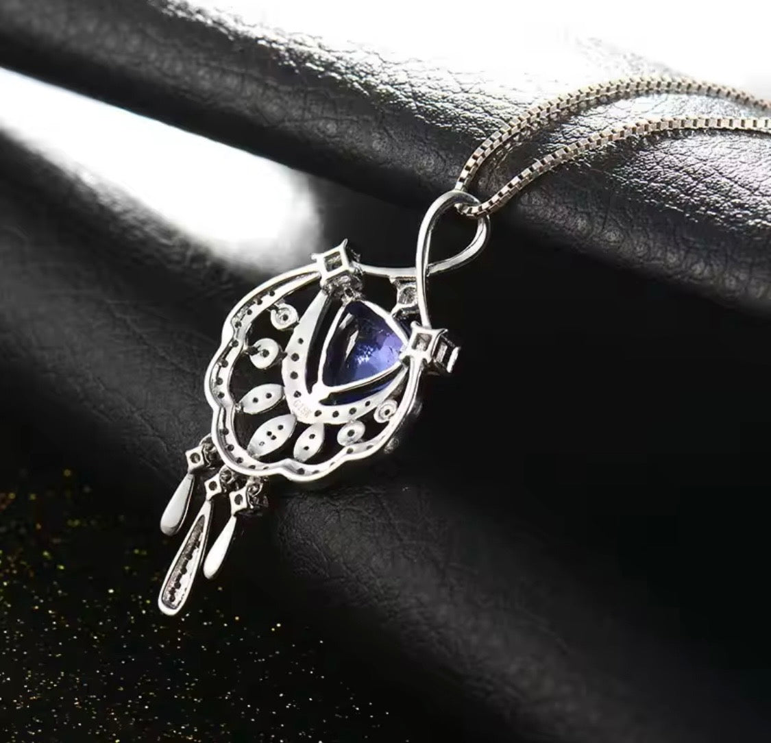 18K gold tanzanite pendant with trillion cut gemstone and diamond design