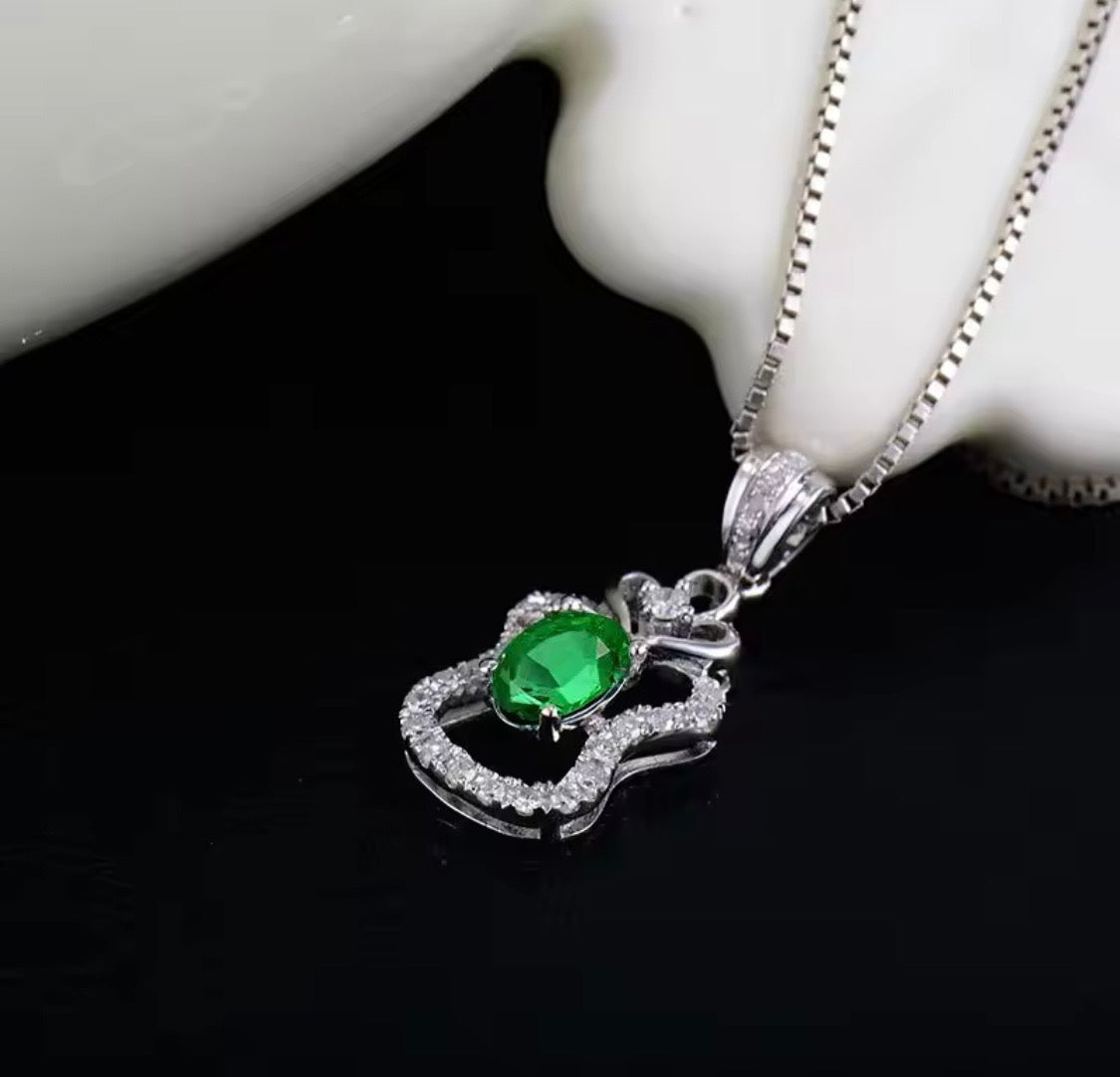 18K white gold emerald diamond pendant with 0.45 carat oval natural emerald and heart halo design