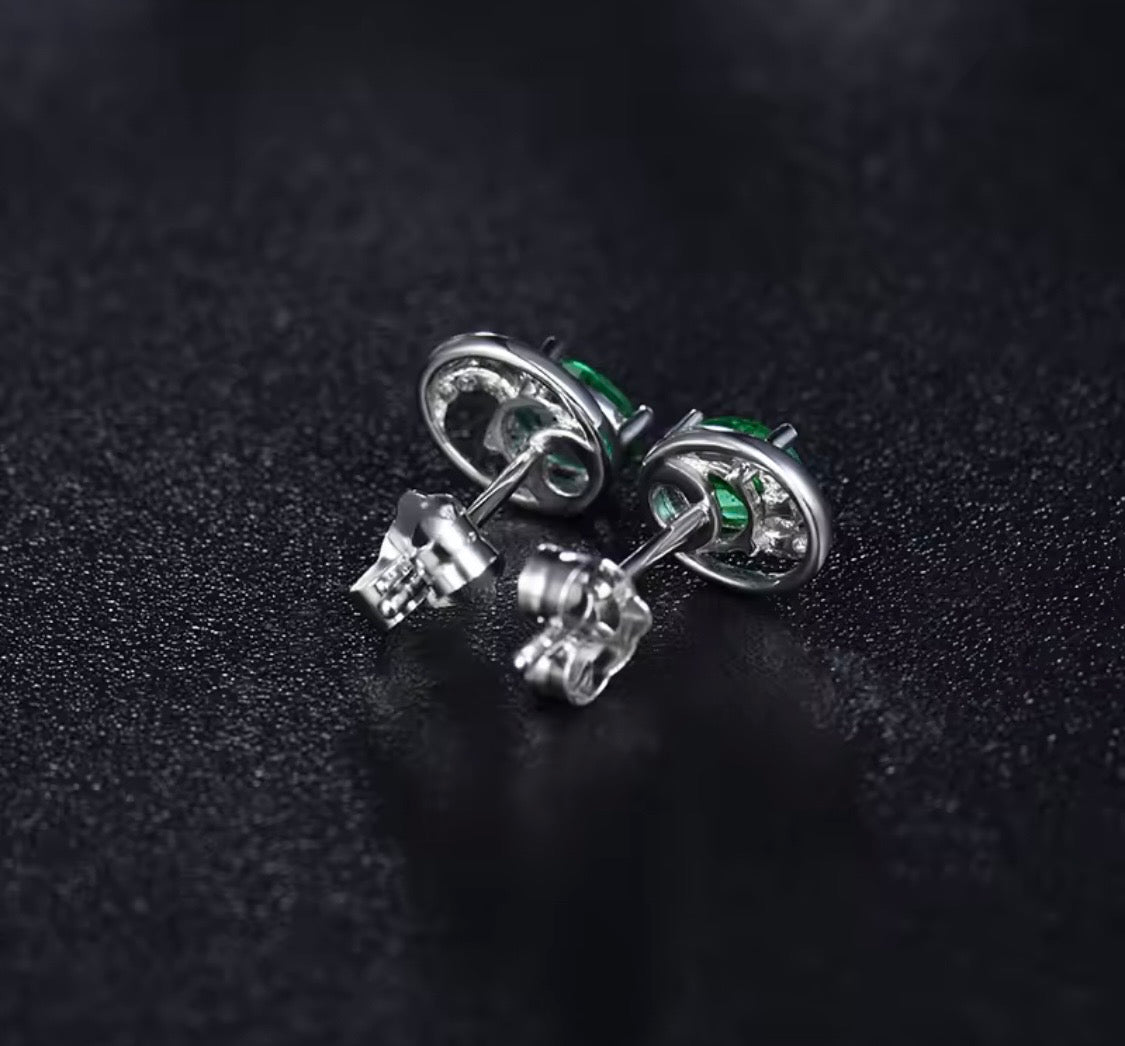 18K gold emerald stud earrings with oval 4x5mm gemstones and vintage swirl design