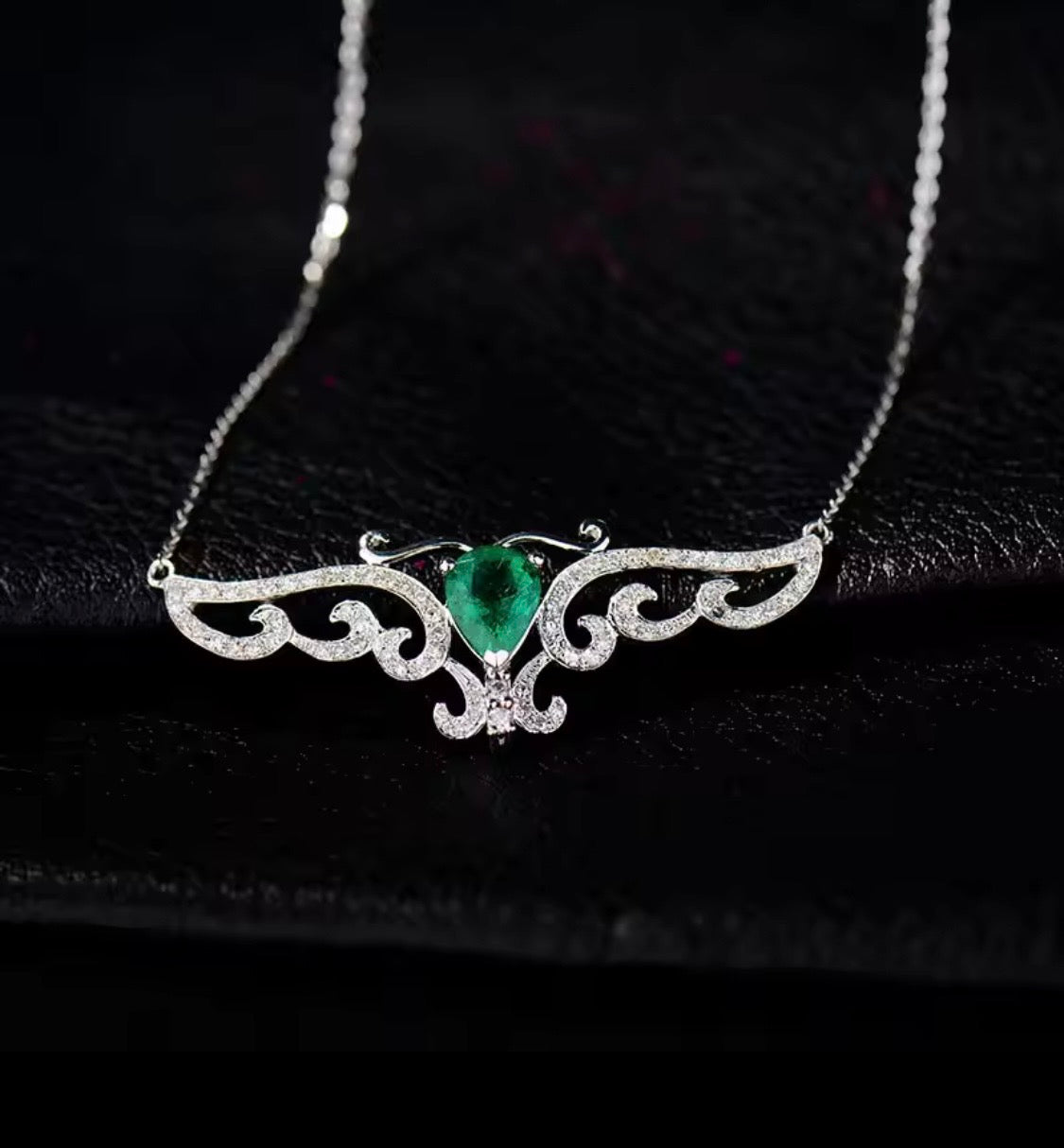 18K gold emerald diamond pendant with 0.66 carat pear cut natural emerald and angel wings design
