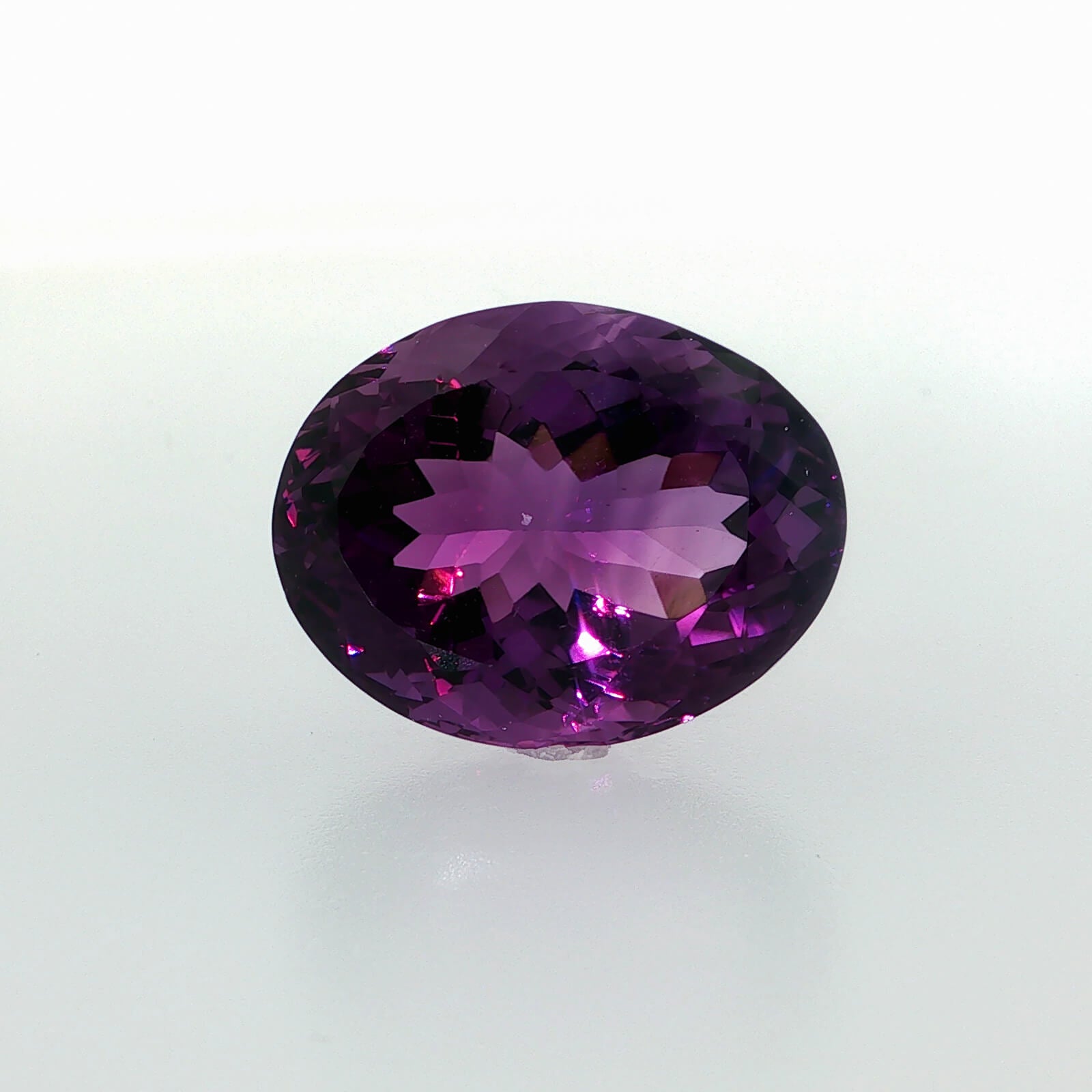 Natural amethyst, 33.56 carats, oval cut, clarity: eye clean, rich purple color, measuring 23.80 × 18.60 × 13.70 mm