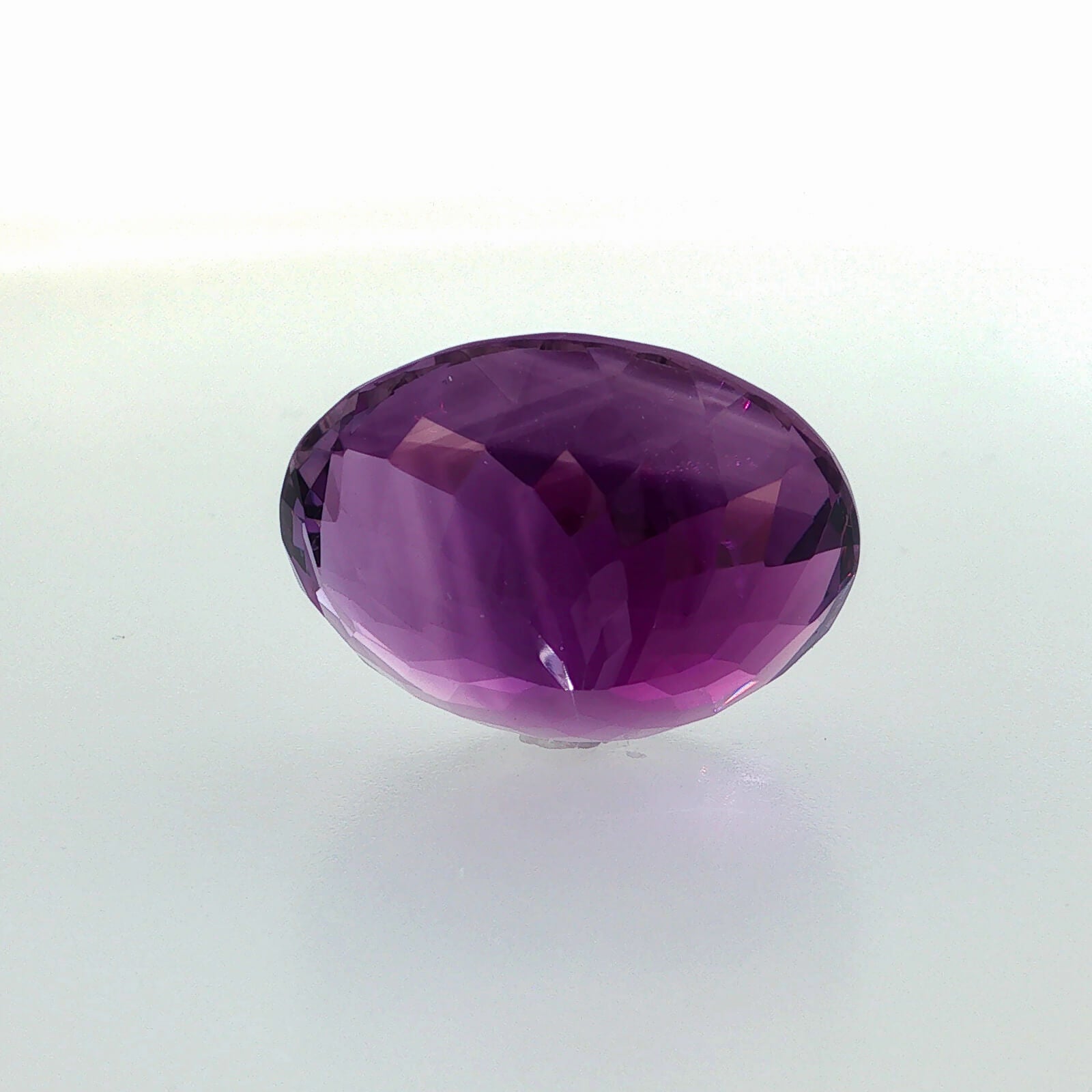 Natural amethyst, 33.56 carats, oval cut, clarity: eye clean, rich purple color, measuring 23.80 × 18.60 × 13.70 mm