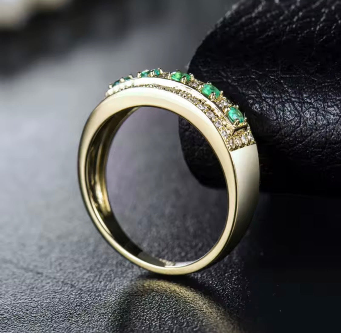Natural emerald and diamond band ring in solid 18K yellow gold side view