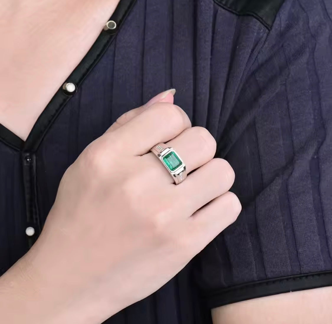 Natural emerald and diamond unisex ring in 18K white gold worn on hand
