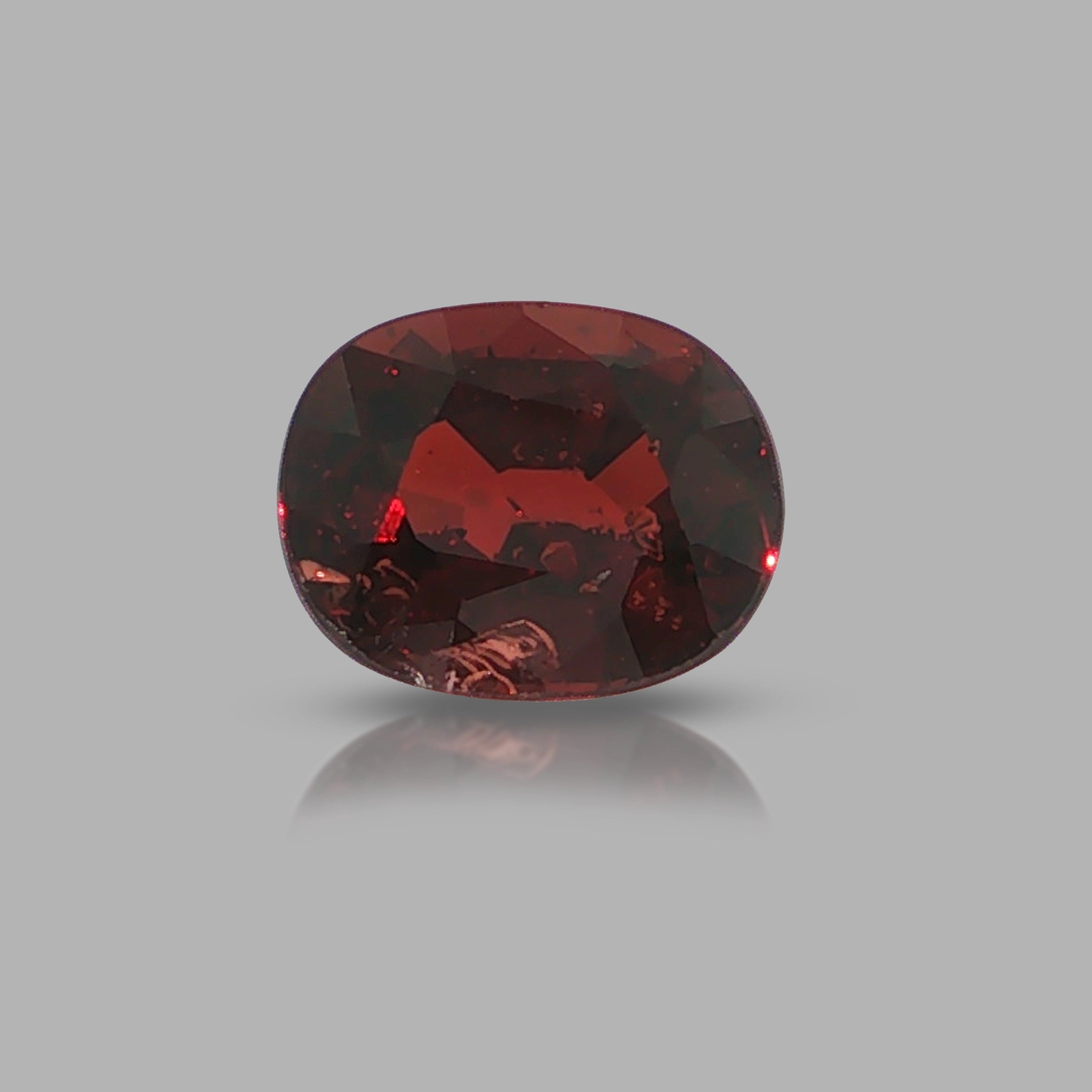 Natural pyrope-almandine garnet, 2.39 carats, oval cut, slightly orangy red color, transparent, ČGL certified gemstone