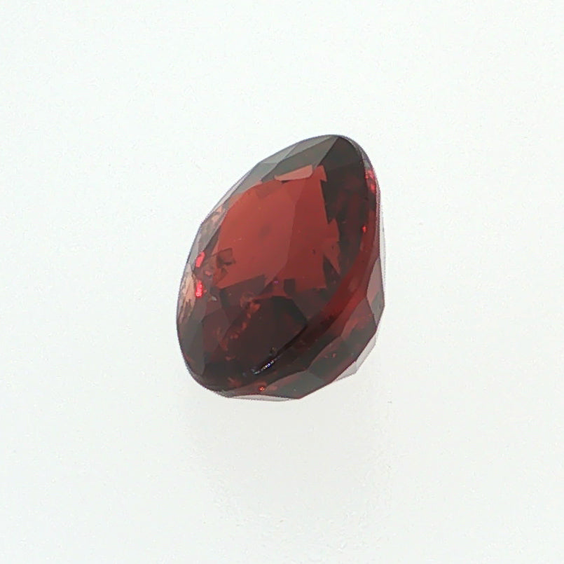 Natural pyrope-almandine garnet, 2.39 carats, oval cut, slightly orangy red color, transparent, ČGL certified gemstone