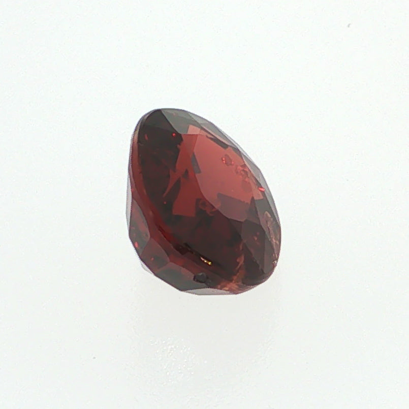 Natural pyrope-almandine garnet, 2.39 carats, oval cut, slightly orangy red color, transparent, ČGL certified gemstone