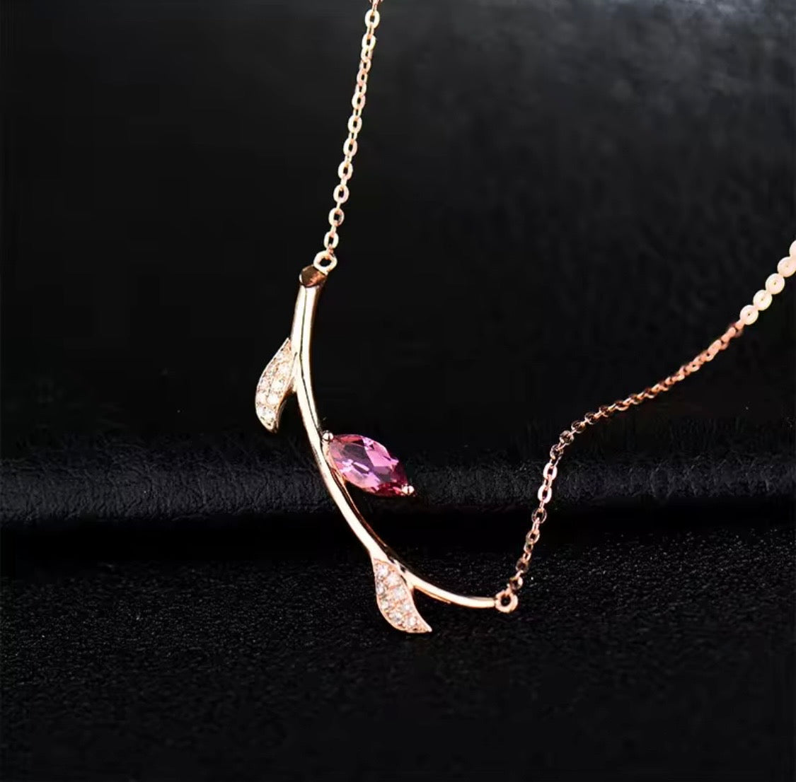 Natural pink tourmaline and diamond botanical necklace in 18K rose gold angle view