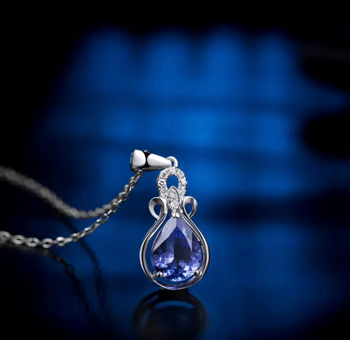 Natural pear tanzanite and diamond pendant in 14K white gold lifestyle view