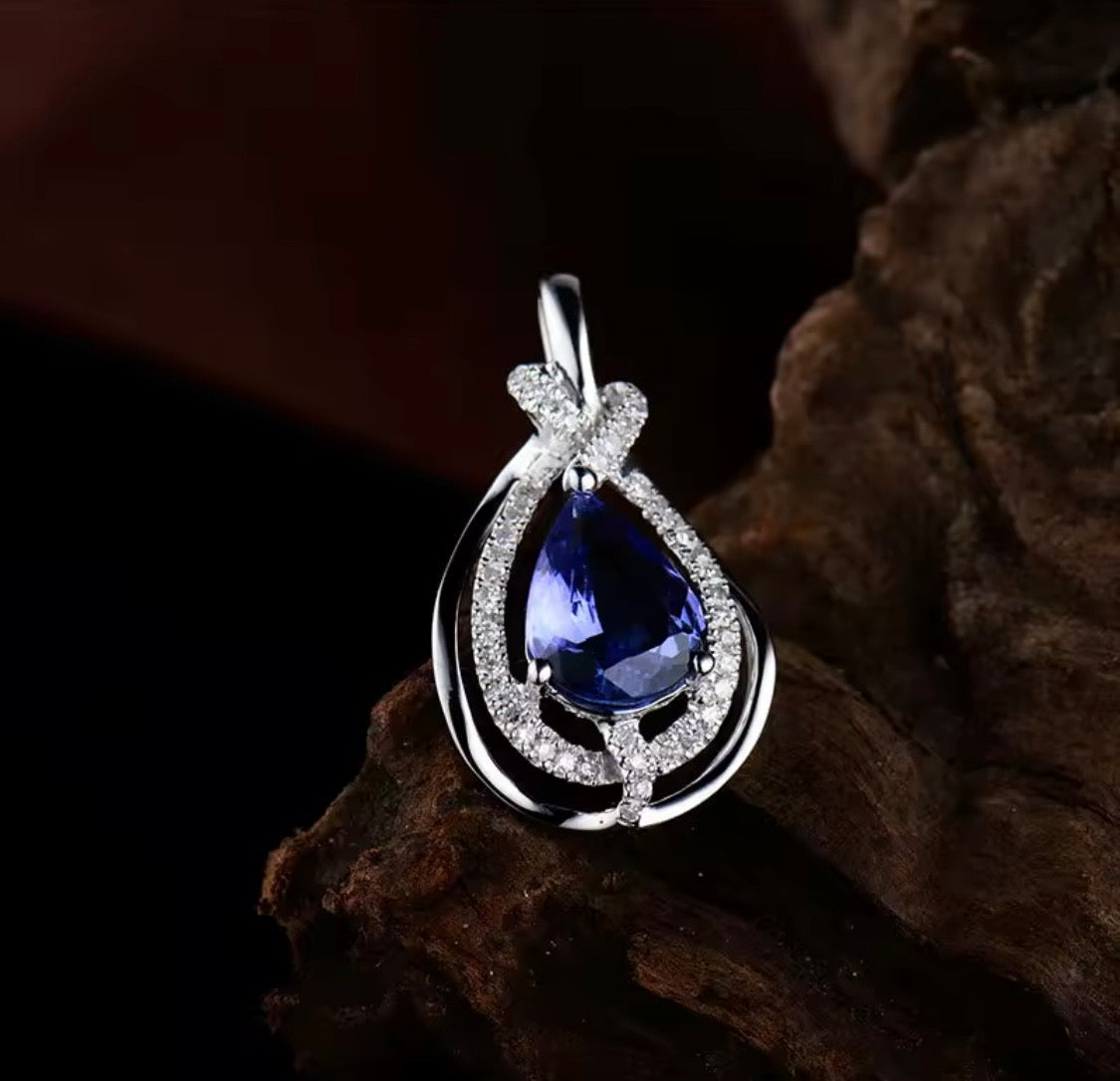 Natural pear tanzanite and diamond pendant in 18K white gold lifestyle view
