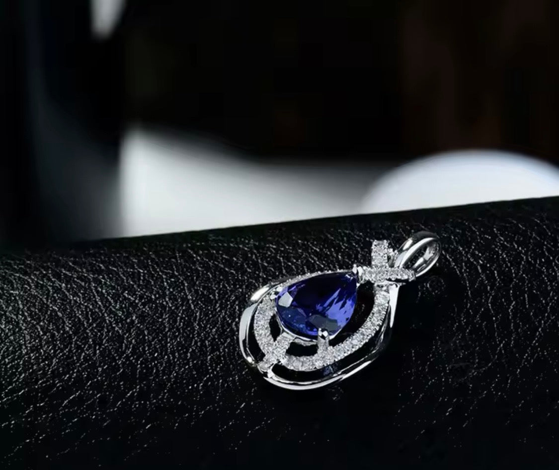 Natural pear tanzanite diamond pendant in 18K white gold side profile