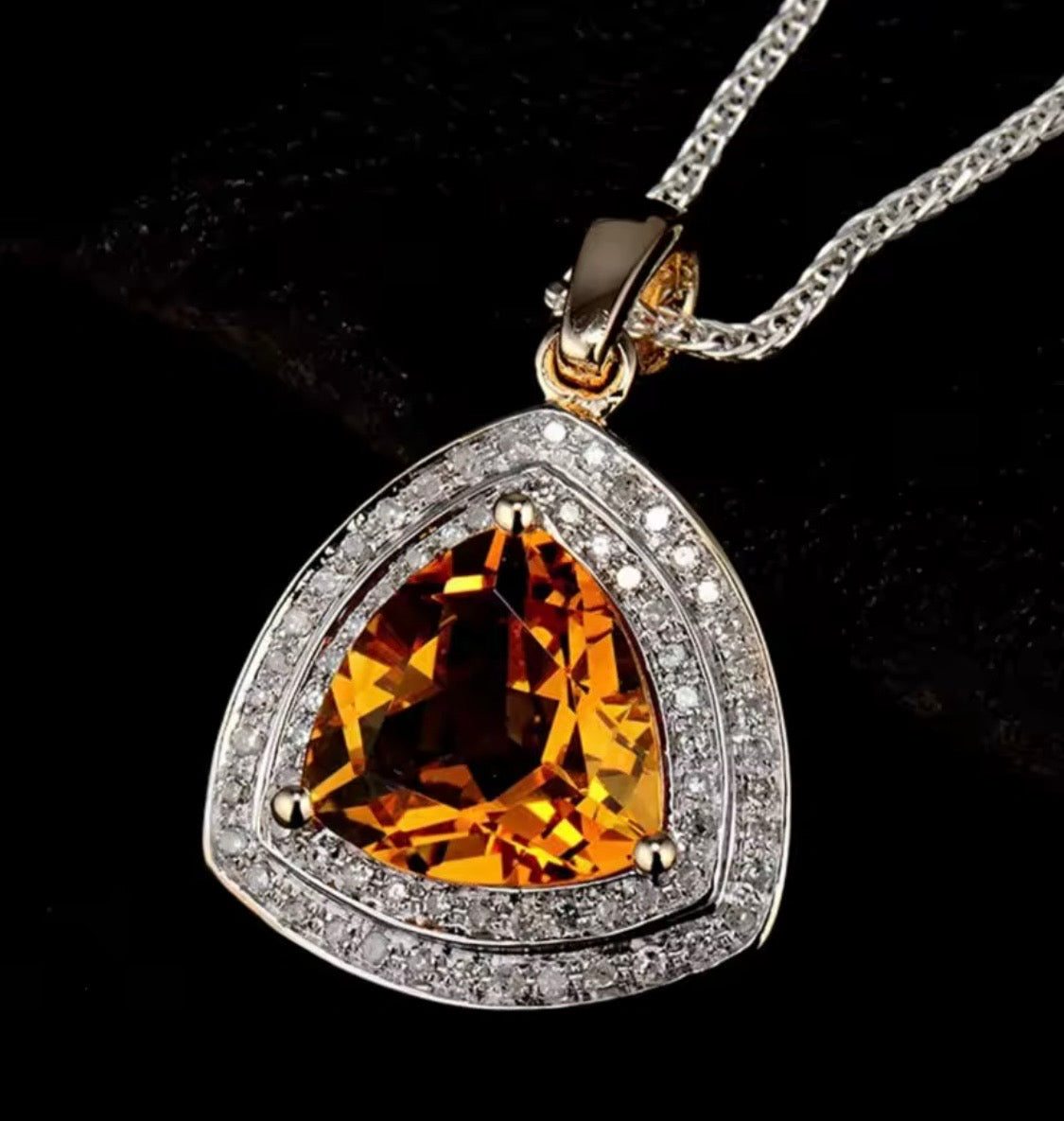 Close-up of natural trillion citrine and diamond pendant in 14K yellow gold