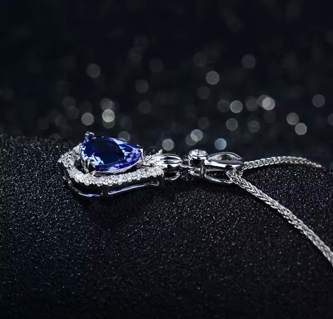 Natural trillion tanzanite and diamond pendant in 18K white gold side view