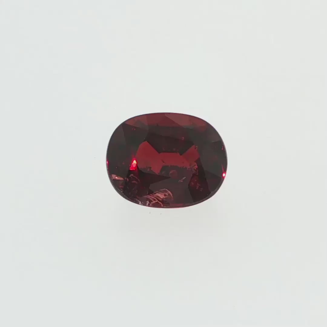 Natural pyrope-almandine garnet, 2.39 carats, oval cut, slightly orangy red color, transparent, ČGL certified gemstone