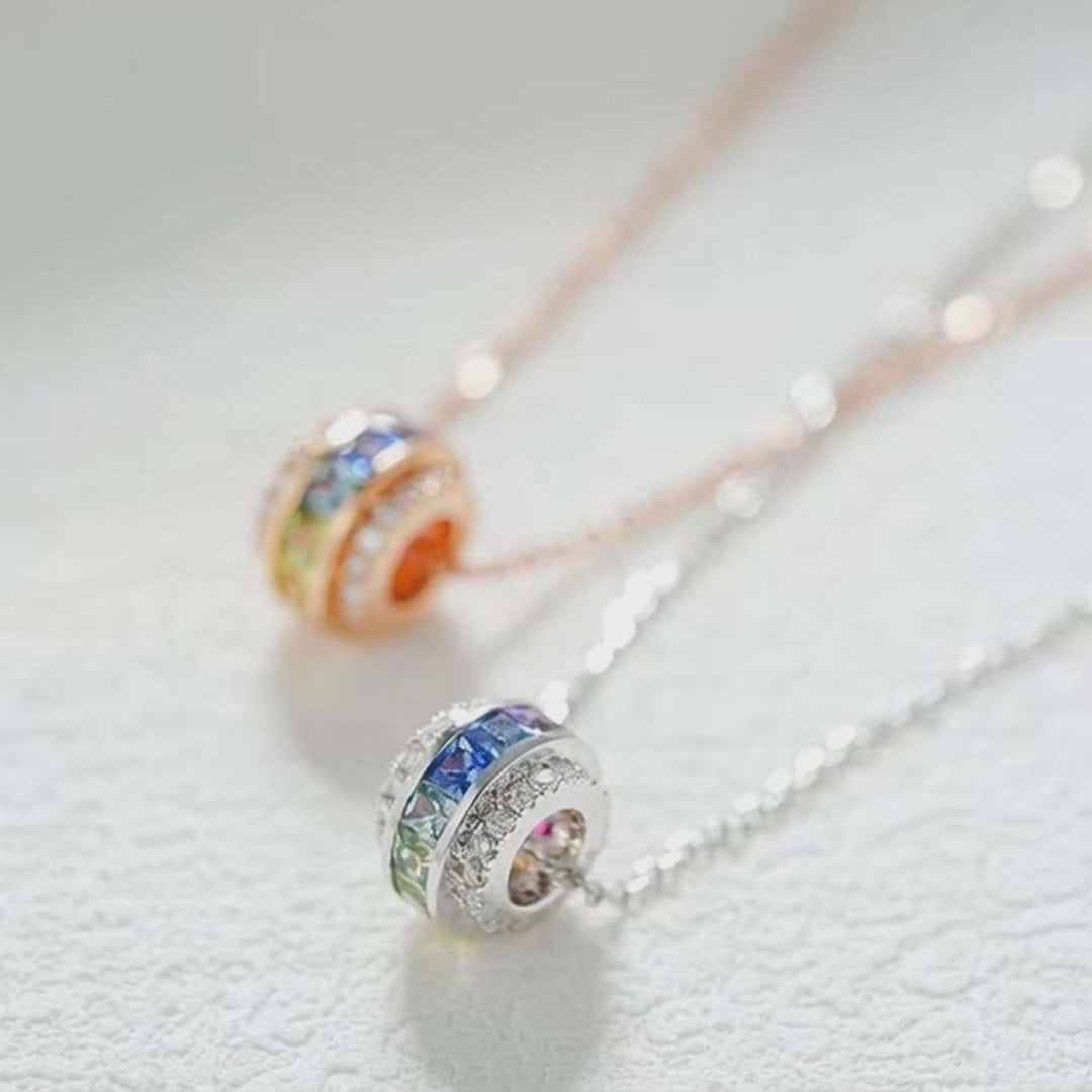 18K yellow or white gold circular pendant with multicolor channel-set princess-cut sapphires and diamond accents, eternity-style design.