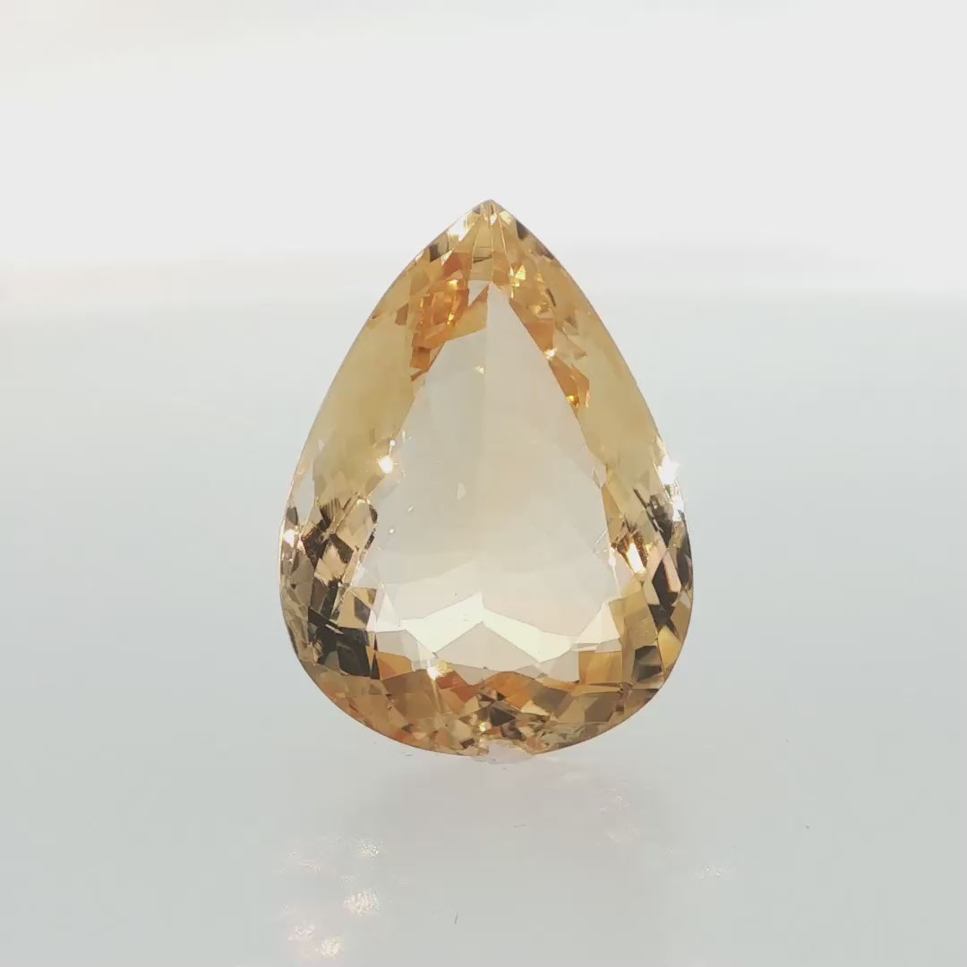Natural citrine, 29.25 carats, pear cut, eye-clean clarity, golden-yellow color, measuring 25.74 × 19.19 × 10.96 mm