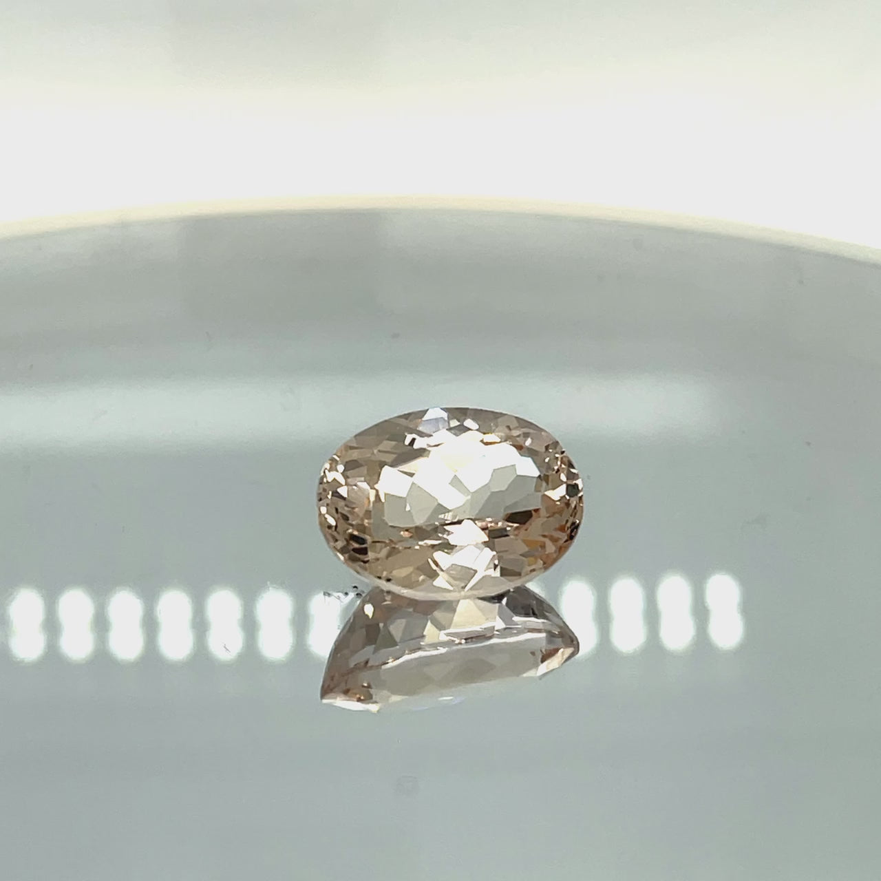 Natural morganite, 11.70 carats, oval cut, VVS clarity, unheated, light pinkish-peach color