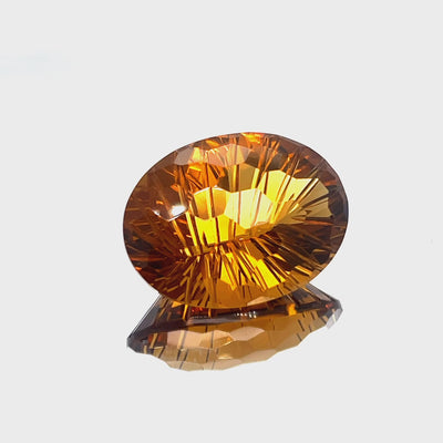 Natural honey citrine, 30.59 carats, oval honeycomb cut, IF clarity, untreated, honey orange color