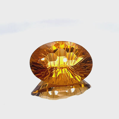 Natural honey citrine, 35.05 carats, oval honeycomb cut, IF clarity, untreated, honey orange color