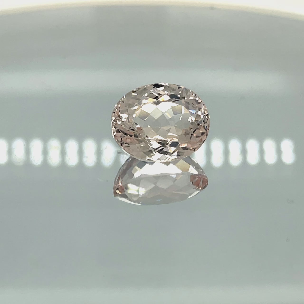 Natural morganite, 12.27 carats, oval cut, VVS clarity, unheated, light pinkish-peach gemstone
