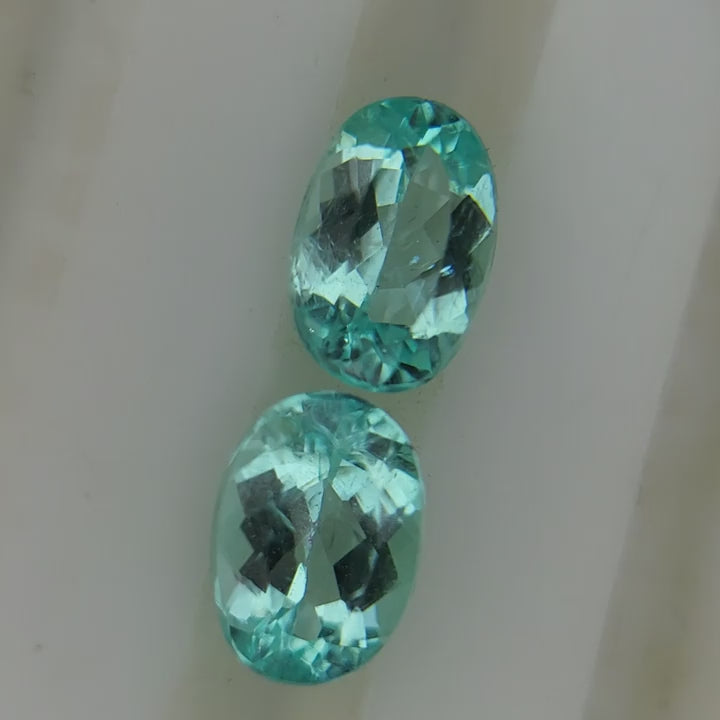 Natural Paraiba tourmaline pair, 2.58 carats total, oval cut, neon blue, heated, AIGS certified