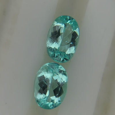 Natural Paraiba tourmaline pair, 2.58 carats total, oval cut, neon blue, heated, AIGS certified