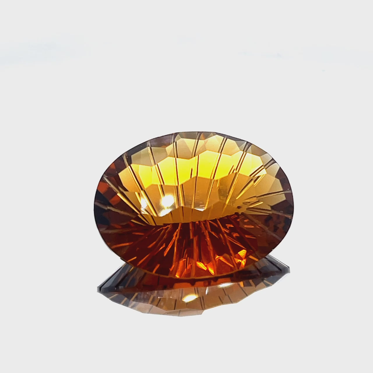 Natural honey citrine, 26.11 carats, oval honeycomb cut, IF clarity, untreated, honey orange color