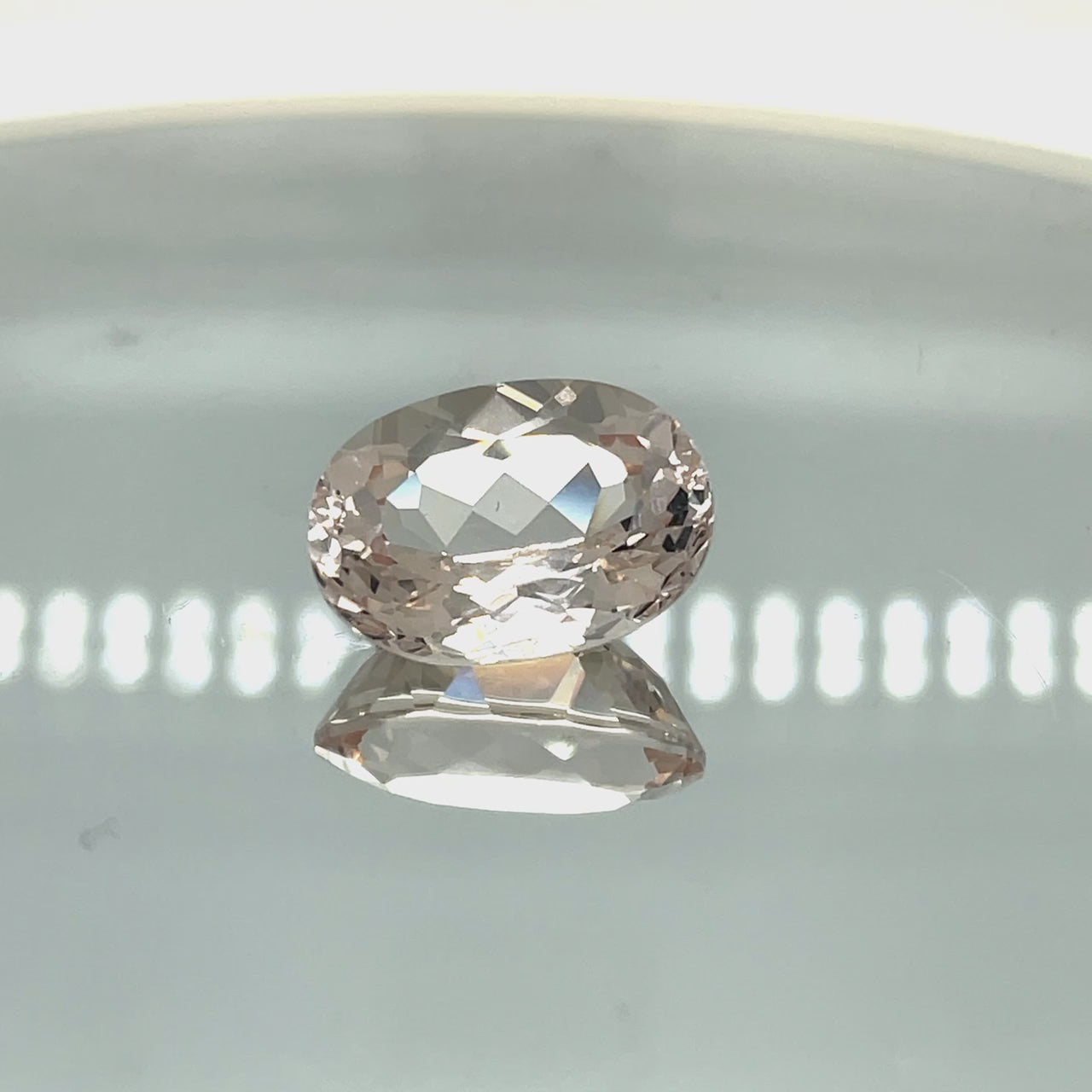 Natural morganite, 13.59 carats, oval cut, VVS–IF clarity, unheated, light pinkish-peach gemstone