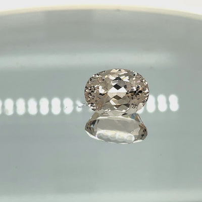 Natural morganite, 10.24 carats, oval cut, VVS clarity, unheated, light pinkish-peach color