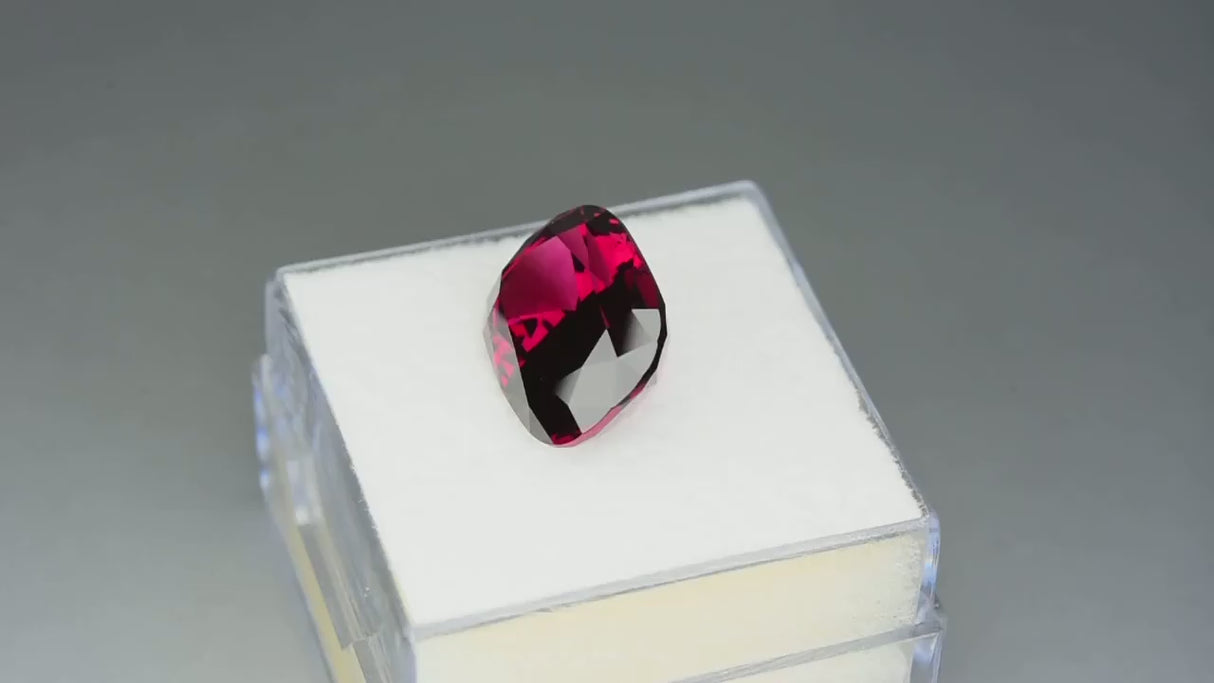 Natural Umbalite garnet, 7.18 carats, purplish-red color, cushion cut, loupe clean, untreated