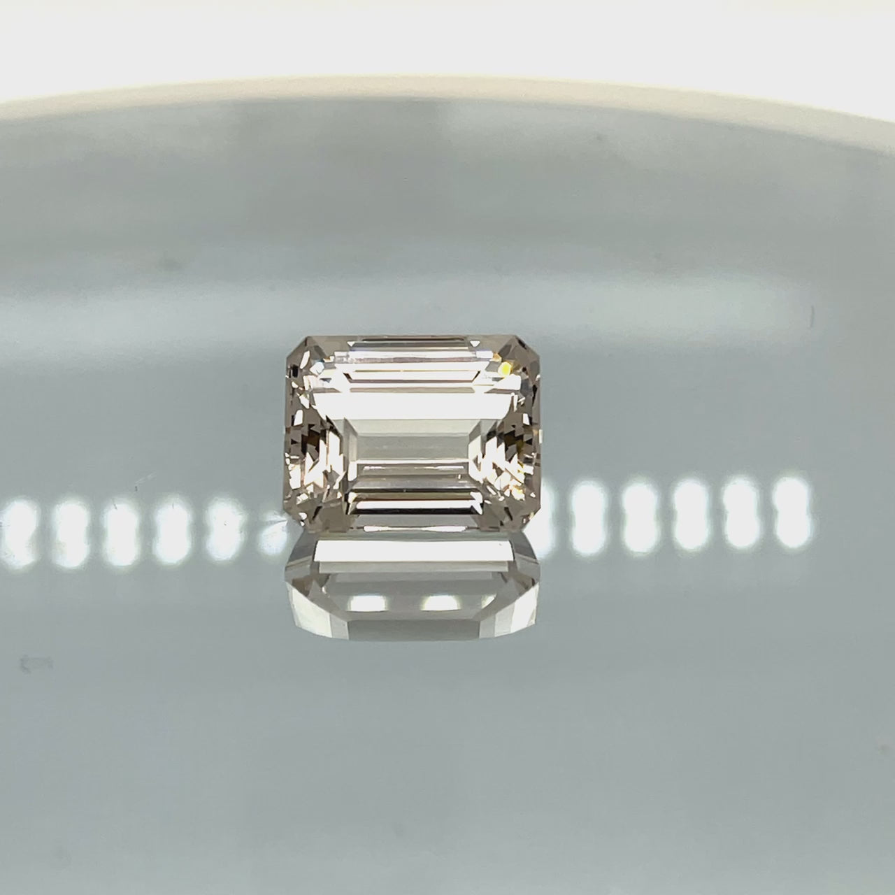 Natural morganite, 10.70 carats, emerald cut, VVS clarity, unheated, light pinkish-peach gemstone