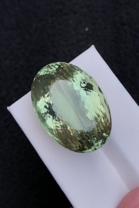 Natural prasiolite, 57.05 carats, oval faceted cut, heat treated, pastel green color