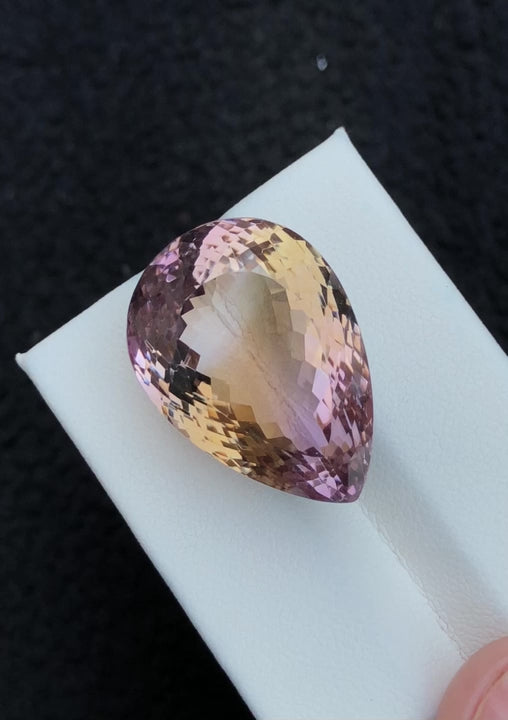 Natural ametrine, 39.50 carats, pear faceted cut, heat treated, purple and golden-yellow bi-color gemstone
