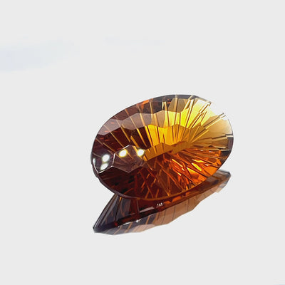 Natural honey citrine, 36.39 carats, oval honeycomb cut, IF clarity, untreated, honey-orange color