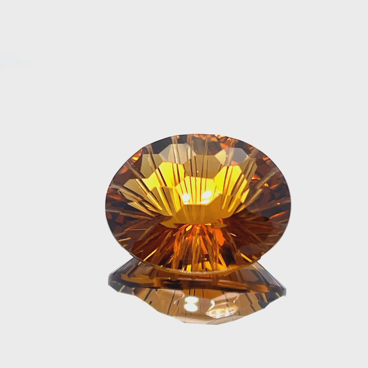 Natural honey citrine, 25.78 carats, oval honeycomb cut, IF clarity, untreated, honey orange color