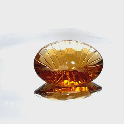 Natural honey citrine, 69.06 carats, oval honeycomb cut, IF clarity, untreated, honey-orange color